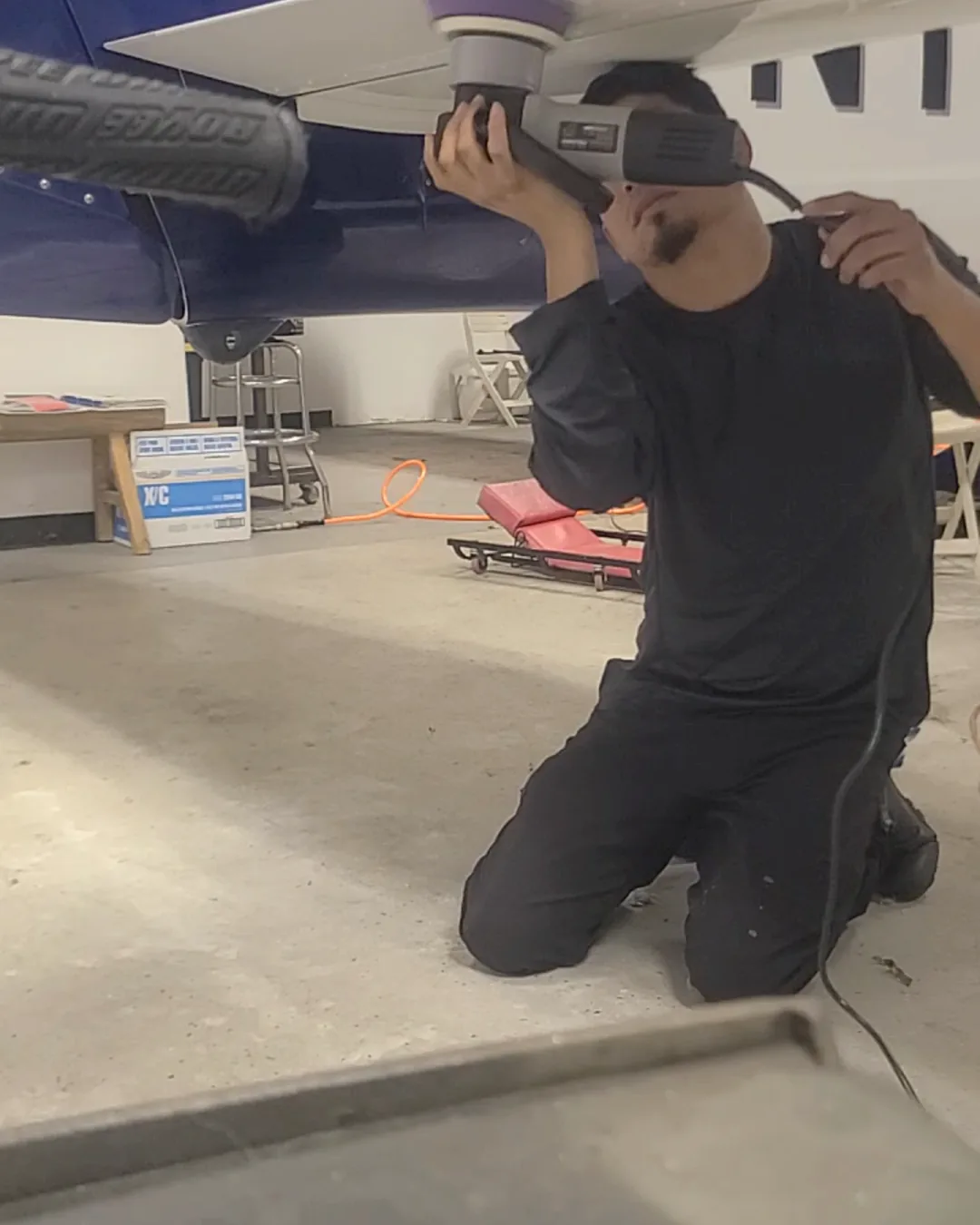 Rotary polisher working paint under a jet wing