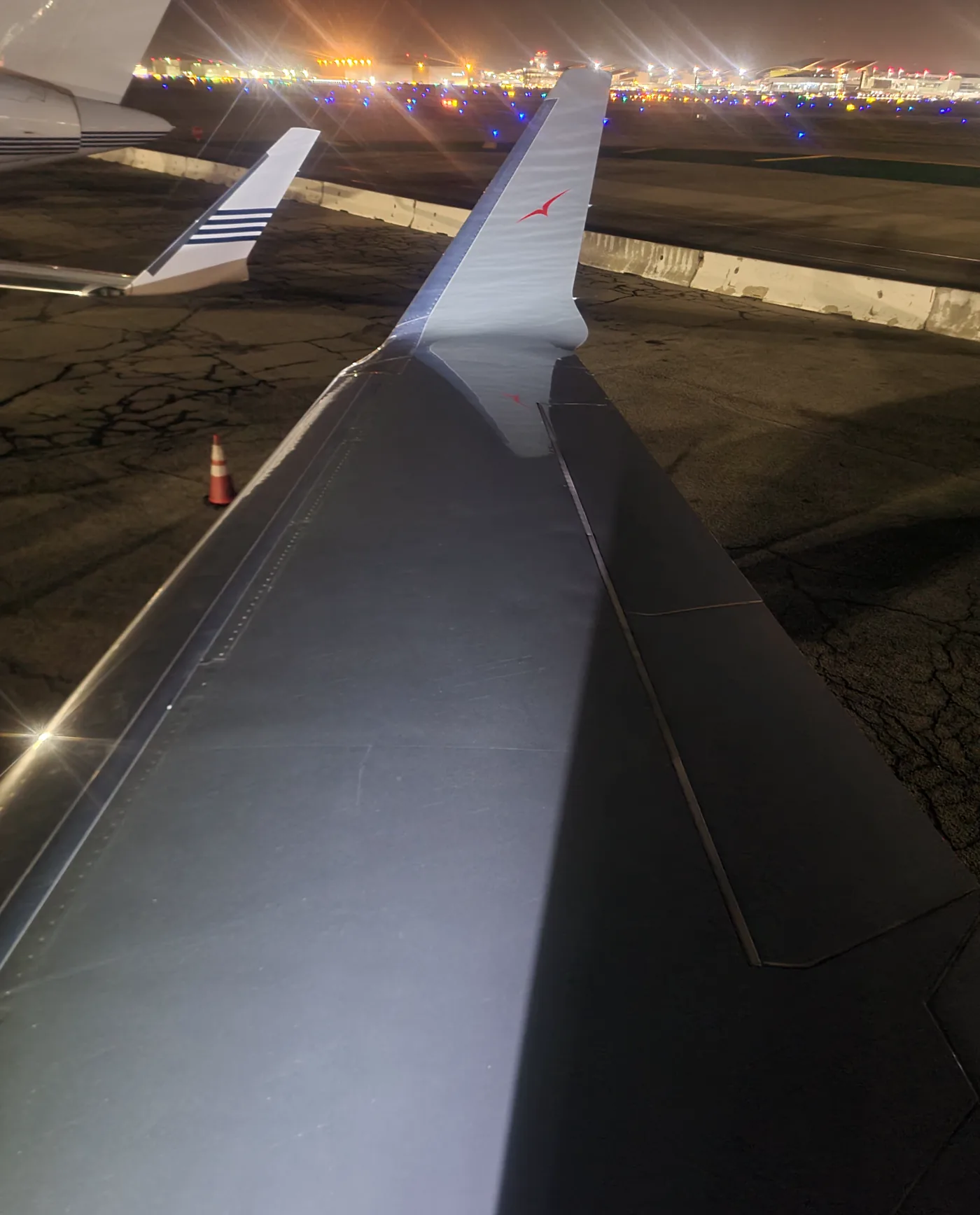 Aircraft wing at night on a California airport ramp