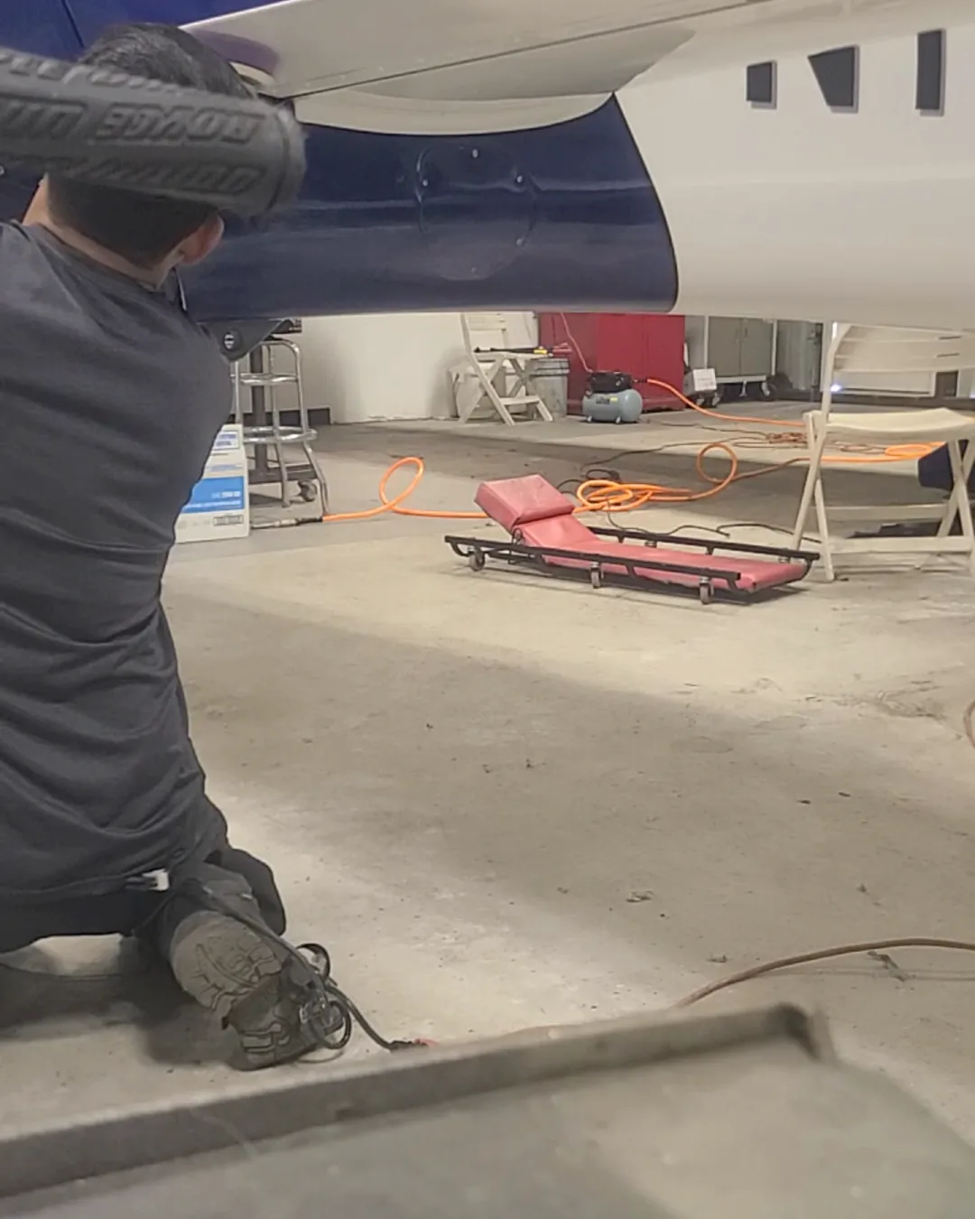 Aircraft wing polishing in progress inside a hangar